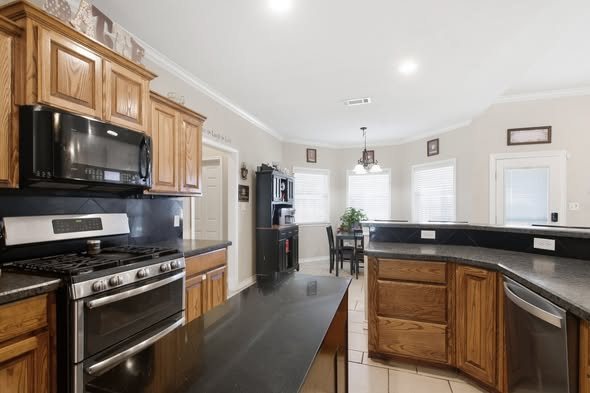 Kitchen with wood cabinets and gas range